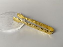 Pinzas doradas para carbón